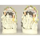 A pair of Victorian Staffordshire figures with meeting at the fountain, height 19cm (2)