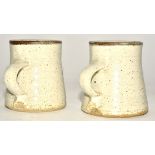 Michael Cole (Contemporary) a pair of stoneware ash and iron glazed thrown mugs, with strap