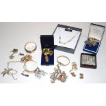 A pair of gold cufflinks, 8.3g, a silver heart chain-link charm bracelet with multiple objet d'art