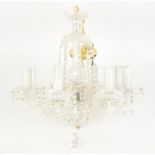 A contemporary glass chandelier, of eight branched form, supporting floral bowls with faceted