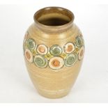 A Denby stoneware vase, with orange, yellow and green raised circles and spirals, on a beige ground,