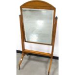 A Sheraton revival satinwood cheval mirror, bevelled plate in arch top frame with herringbone
