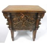 A 19th Century continental elm chest of small proportions, rising top, front and rear carved with