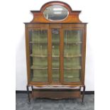 An Edwardian mahogany inlaid double doored display cabinet, with reverse serpentine front, boxwood