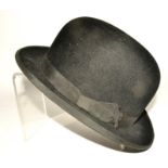 A black bowler hat, retailed by ALF Ogden of Stamford Street, Ashton Under Lyme,