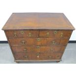 An 18th Century walnut chest, of two short above and the long graduated drawers, cross banded,