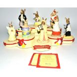 A small collection of Royal Doulton Bunnykins figures together with a Bunnykins resin display stand,