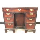 A Queen Anne Style kneehole desk, having single long drawer over central single cupboard, flanked by