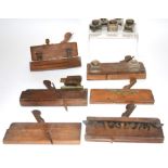Six antique moulding planes, together with a small collection of writing slope inkwells, plus