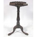 A 18th Century mahogany tripod table, octagonal top with shaped gallery, candle slide, turned column