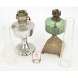 Two British 20th Century oil lamps, one on a cast metal pyramid base with green glass, height