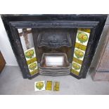 An Art Nouveau cast iron combination fireplace, blacked cast iron surround with original floral