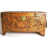 An Oriental camphor wood lined blanket box, with scenes of figures on horseback, 87.5cm x 48cm x