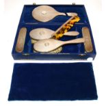 A George VI hallmarked silver dressing table set, London Maker, consisting of four brushes, one comb