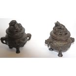 Two Chinese bronze koro, of footed circular form, cast in relief with panels of birds,