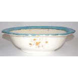 A ceramic wash bowl with transfer print of birds and turquoise border, measuring 48cm x 37cm x 12cm