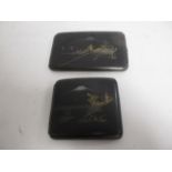 Two Japanese Shakudoware cigarette holders, both with decorative covers depicting mountainous