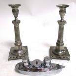 A pair of Munka Swedish candlestick holders, of Corinthian form, raised upon four feet, height 26cm,