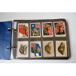An album of four silk full sets, Godfrey Phillips Flags 7th Series (120), Wills Birds and Animals of