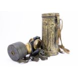 A WWII German Africa Corps Gas Mask, in original sandy coloured tin with carry straps, the mask in