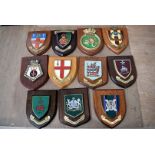 A group of various wooden wall plaques, various regiments and ages, to include Lowland Brigade,