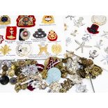 A large collection of cap and cloth badges, to include The Border Regt, The Essex Regt, RASC,