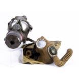 Two WWII period gas masks, one dated 1937, with canvas carry bag, both with original filters (