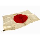 A WWII Japanese Red Rising Sun flag, with ties to one corner, with black strengthening material,