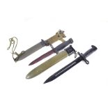 A 1942 dated US M1 knife bayonet, with scabbard, together with a US M7 knife bayonet US M8A1