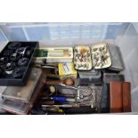 A large assortment of fishing equipment and spares, to include flies, lures, various spools, spare