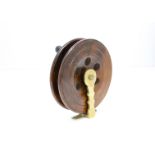 A vintage mahogany and brass Sea Fishing reel, stamped G.H to the foot, also stamped Eton Sun, 7"