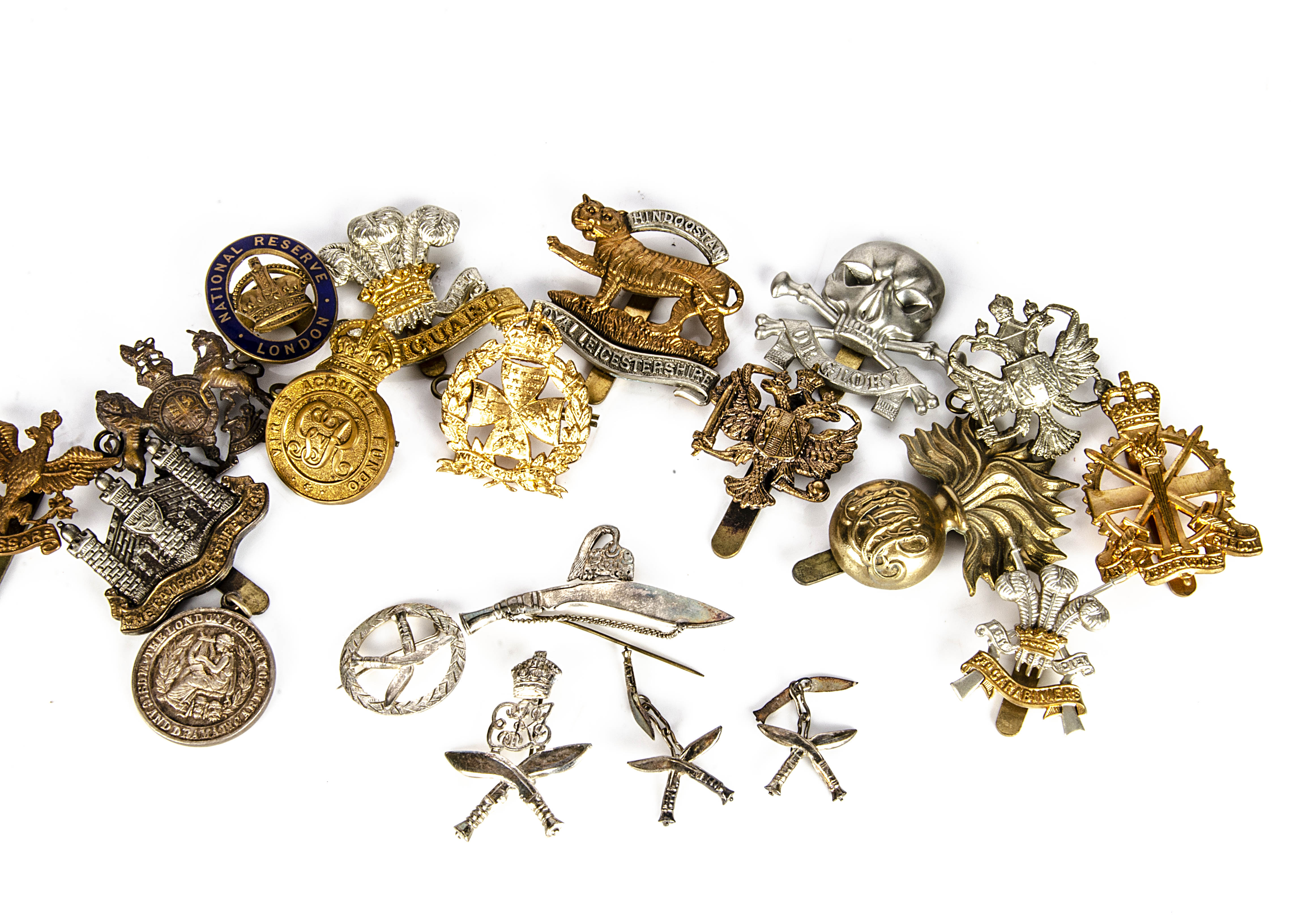 A collection of various cap badges and buttons, to include, white metal cufflinks and pin badges for