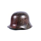 A WWI German M16 camo helmet, complete with original liner and chin strap, chin strap marked '