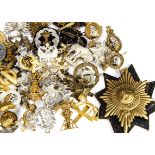 A group of approximately 60 British cap badges, including Machine Gun Guards, marked 1916, 16th