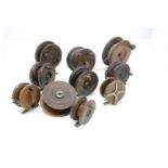 An assortment of ten brass and wooden fishing reels, all unnamed, 3" - 5", including a couple