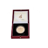 A modern Royal Mint Millenium Gold Proof Crown coin, in fitted box with certificate 0605, approx