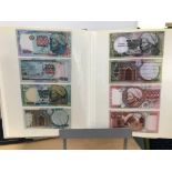 A folder of World bank notes, including examples from Kyrgystan, Kazakstan, Mongolia, Mali, Peru,