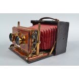 A Lizars Challenge Half Plate Stereo Field Camera, square-cornered tapered red bellows, focusing