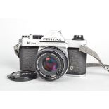 An Asahi Pentax K1000 Camera, serial no 7560381, shutter working, meter responsive, body G, light