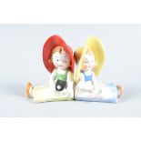 German Goebel Bookend Fairings of Photographic Interest, seated small girls back to back, one in red