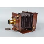 A Rouch's Patent Portable Plate Camera, circa 1885, 6½ x 4¾in, square-cornered tapered bellows, an