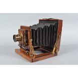 A Half Plate Mahogany Field Camera, square-cornered black bellows, focusing screen missing, double