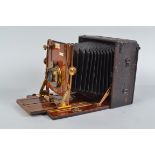 A Sanderson De Luxe Hand and Stand Camera, 6½ x 4¾in, made by Houghtons Ltd, serial no 20035,