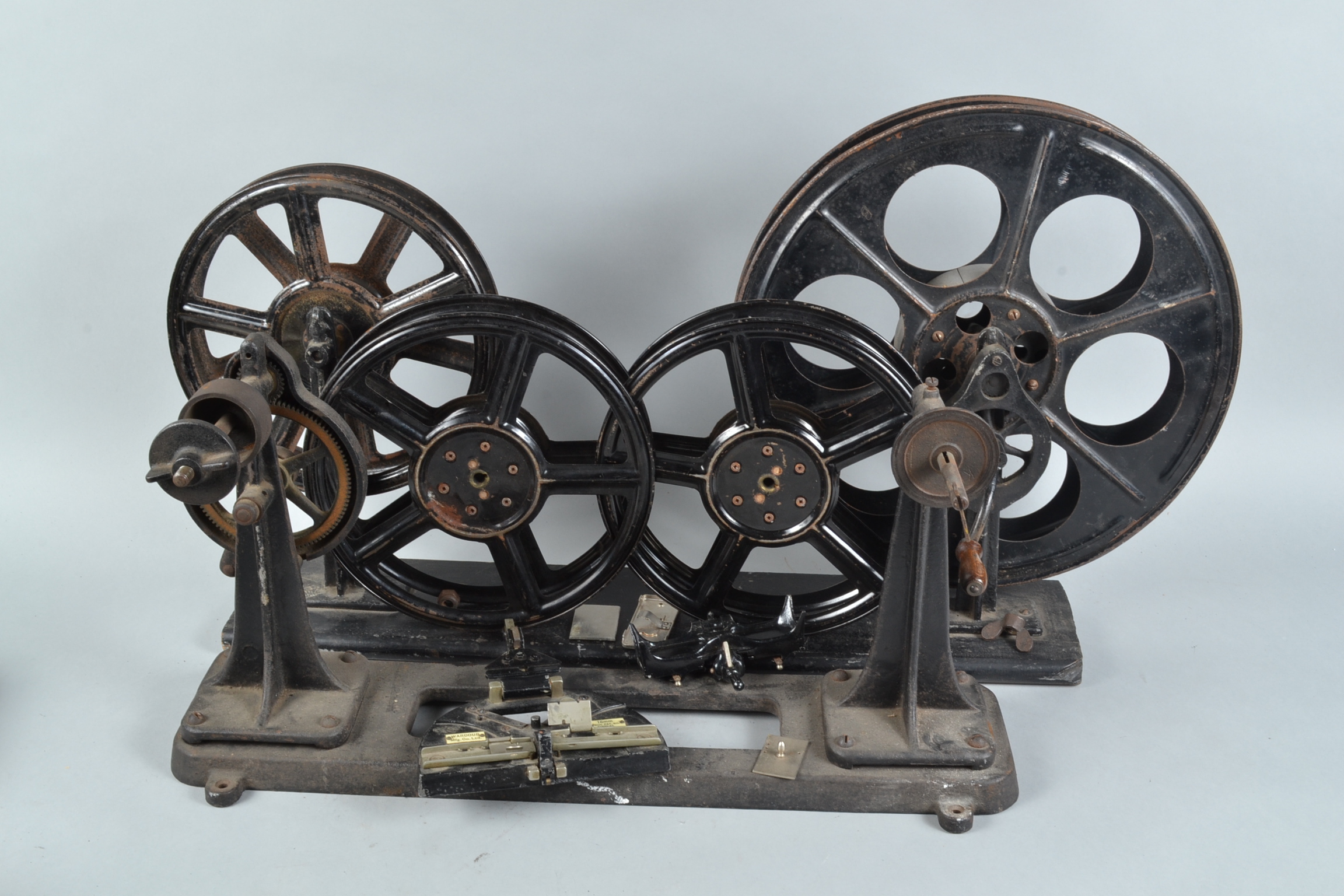 Cinema Projectionist Film Handling Equipment, including two pairs of 35mm film rewinds, mounted on
