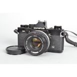 An Olympus OM2 MD Camera, black, serial no 4918017, shutter working, meter responsive, body G,