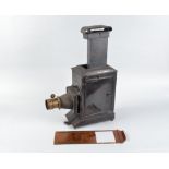 A 19th Century black-painted and Russian Iron Magic Lantern, with brass rack and pinion lens, and