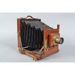A Half Plate Mahogany Field Camera, tapered black bellows, screen present, condition F, with a