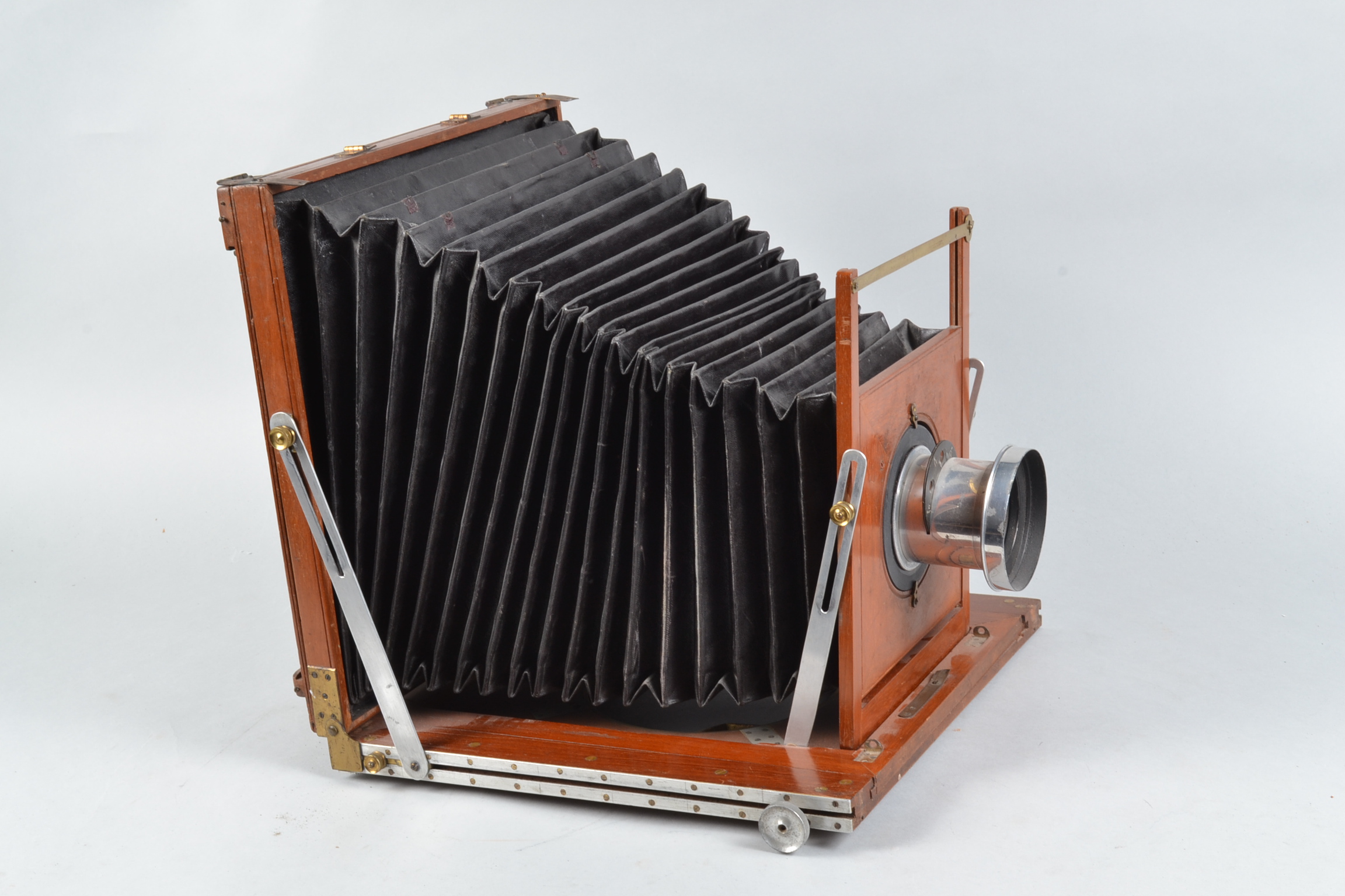 A 12 x 10in Mahogany Stand Camera, square-cornered tapered bellows, rear ground glass present,