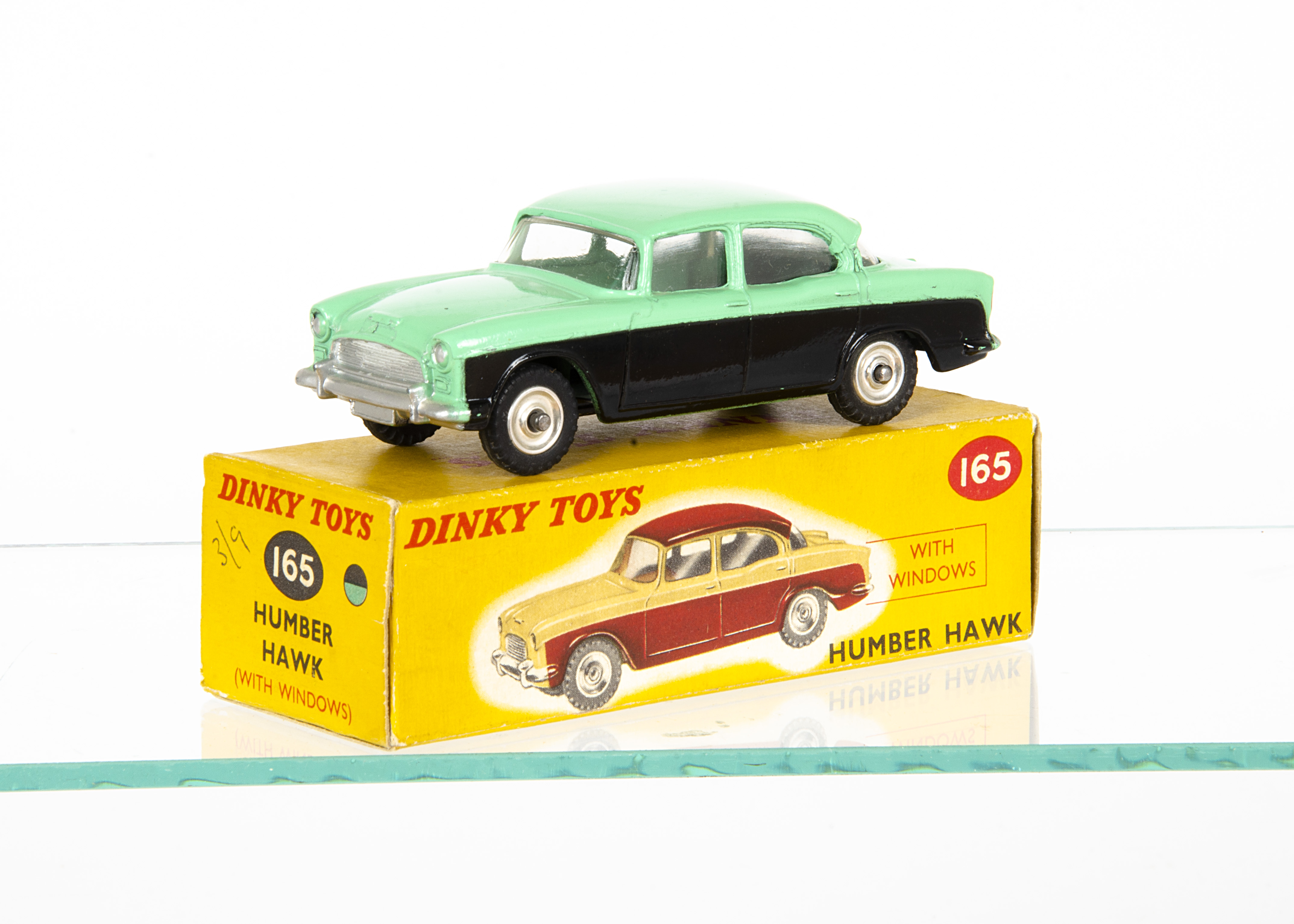A Dinky Toys 165 Humber Hawk, green upper body and roof, black lower body, with front number plate