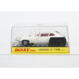 A Dinky Toys 131 Jaguar E Type 2+2, white body, red interior, gold base, cast spoked wheels, in